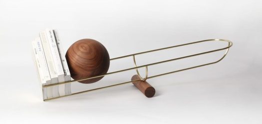 This simple and unique bookshelf is designed like a see-saw, with a wooden ball that rolls depending on where the weight on the shelf is.