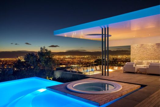 This modern South African house has stunning city views and a swimming pool and spa as well as a sunken outdoor lounge with firepit. 